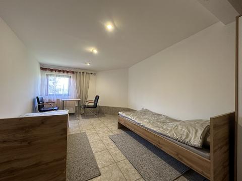 Pokój z dwoma łóżkami, stołem i krzesłami – hostel pracowniczy Częstochowa (3/4)